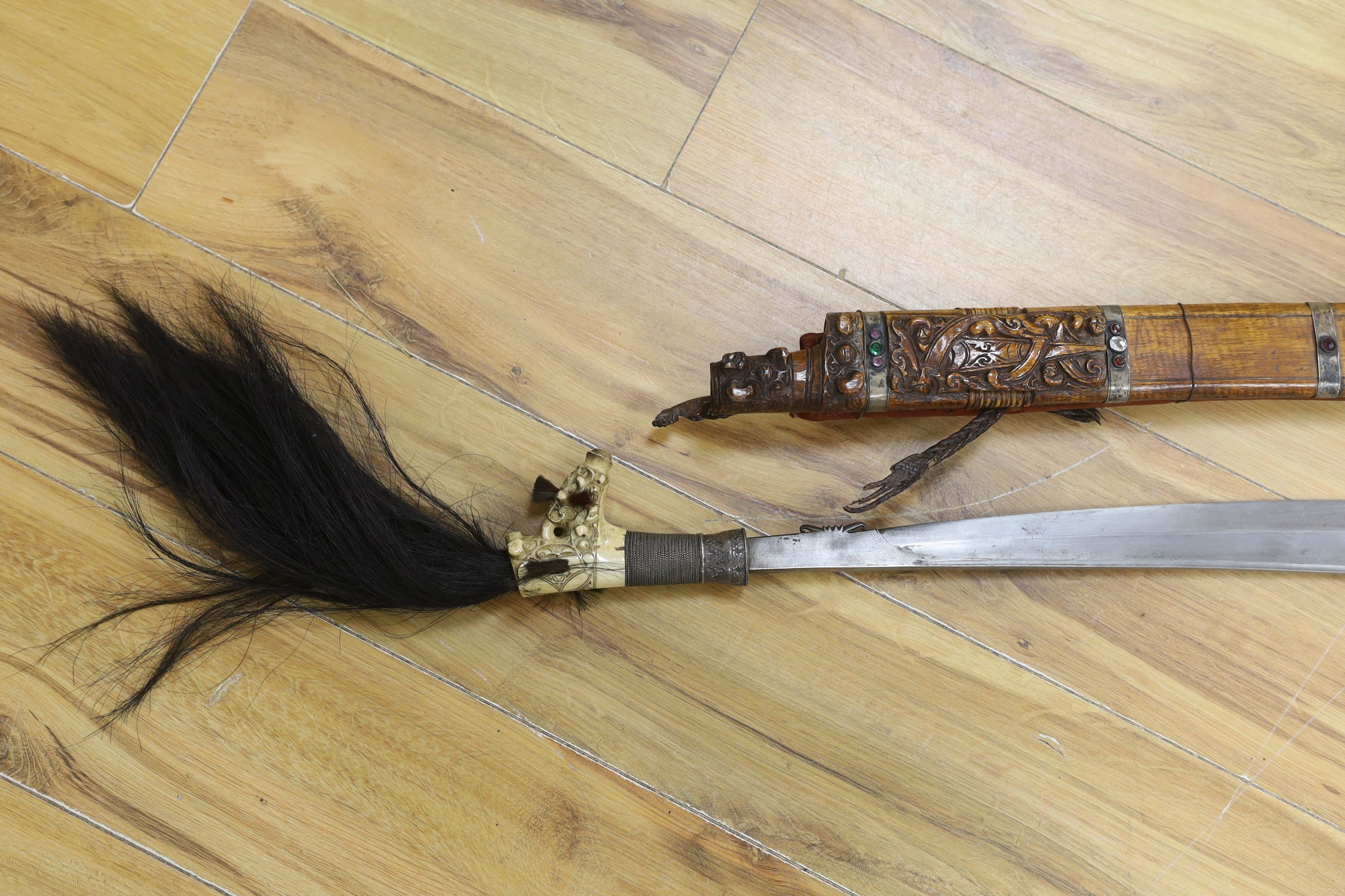 A Borneo 'headhunter's sword', a bone carving and feather swot (3), sword 77 cm long